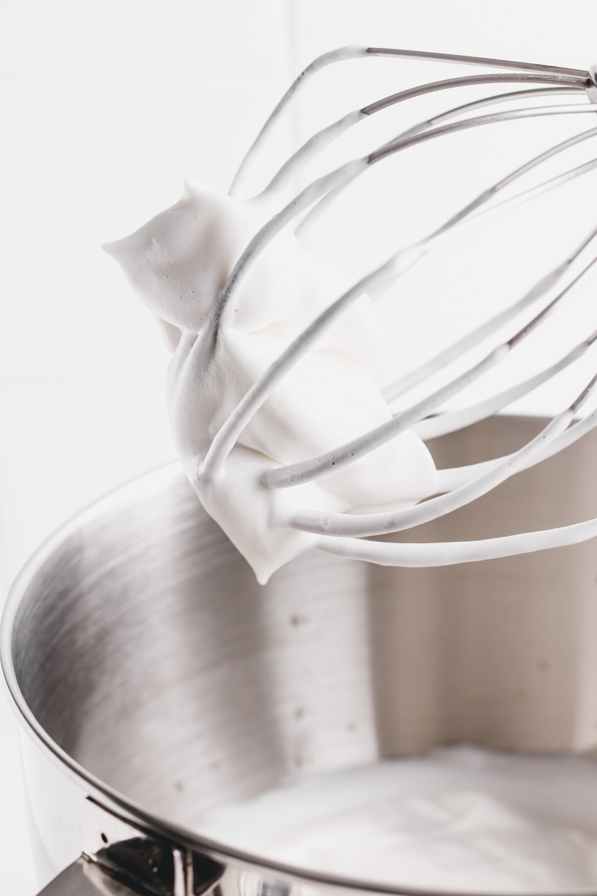 a whisk with whipped aquafaba cream
